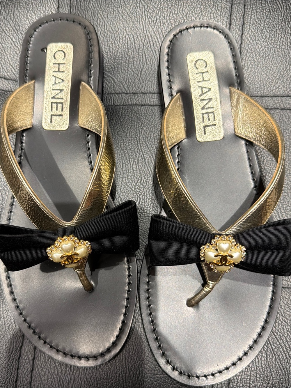 Brand NIB Auth Chanel Metallic Goatskin Grosgrain Bow
adorned w/Pearl CC Thong